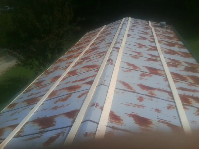 Rusted metal roof panels with new wood purlins before replacement — Storm Damage Roof Repair in Attleboro by Roofing Brothers