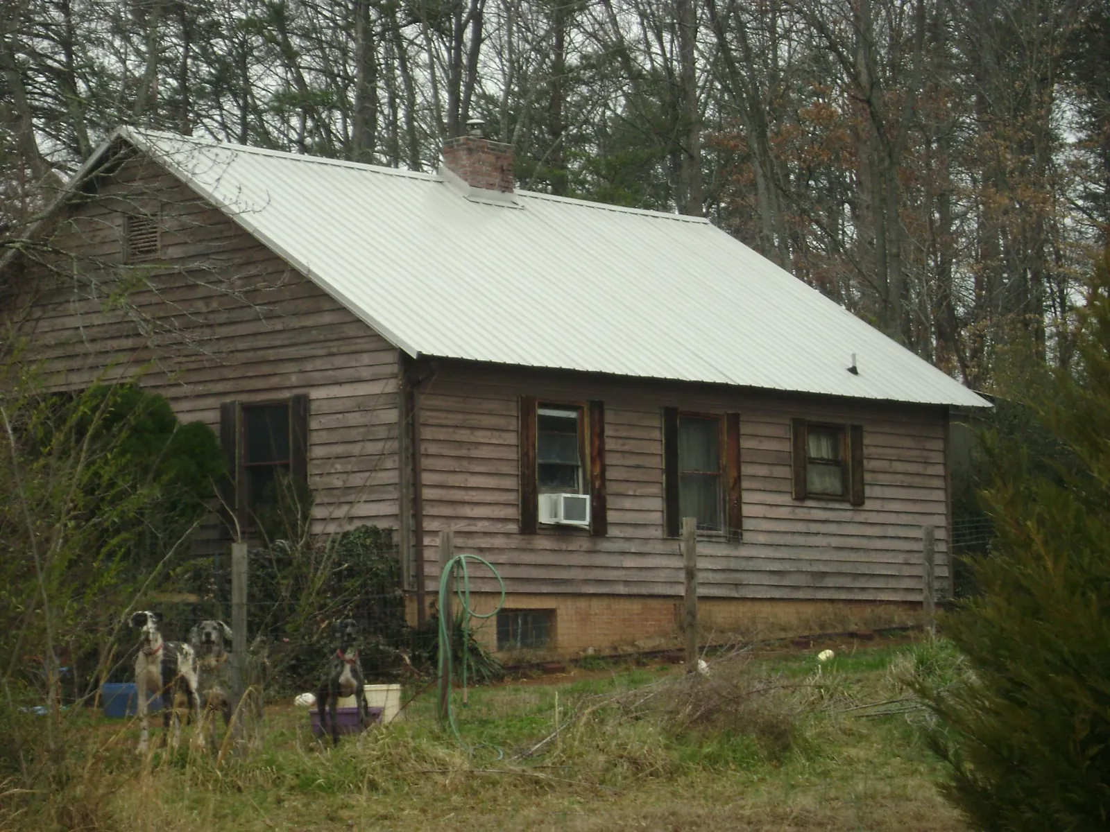 White metal roof on an old wood sided farmhouse, from a Asphalt Shingle Roof Repair job in Attleboro