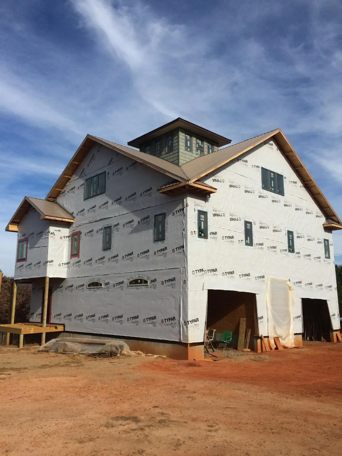 New two story house under construction with a cupola and gabled roofs in Attleboro